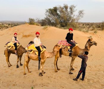 Traditional camel ride through Thar Desert sand dunes